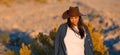 Young cowgirl walking alone through the desert of Nevada