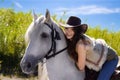 Young cowgirl on white horse smile Royalty Free Stock Photo