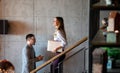 Young business people climb the stairs in the office building Royalty Free Stock Photo