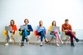 Young coworkers sitting with gadgets on the white wall background Royalty Free Stock Photo