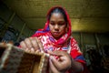 A young crafts maker is making a showpiece from the fibers of a banana tree at Madhupur, Tangail, Bangladesh