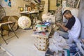 Young craftsman makes tiles for a mosaic, Tangier, Morocco