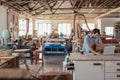 Young craftsman working on a laptop in his woodworking studio