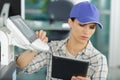 Young craftswoman fixing printer Royalty Free Stock Photo