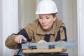 Young craftswoman working with wood