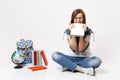 Young crazy curious woman student in glasses holding pencil gnawing biting notebook sitting near globe backpack, school Royalty Free Stock Photo