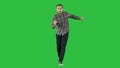 Young crazy man dancing and wanking forward on a Green Screen, Chroma Key.