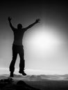 Young crazy man is jumping on mountain peak. Silhouette of jumping man Royalty Free Stock Photo