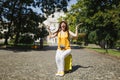 Young crazy traveler tourist woman in hat sitting on suitcase screaming holding city map spreading hands in city outdoor Royalty Free Stock Photo