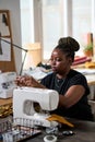 Young creative African American female clothes designer sewing new attire Royalty Free Stock Photo