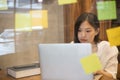 Young creative Asian woman working in modern office.