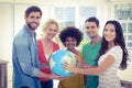 Young creative business people with a globe Royalty Free Stock Photo