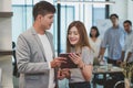 Young creative businessman holding digital tablet with female co Royalty Free Stock Photo