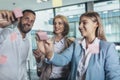 Creative businessman standing with his colleagues writing new ideas on sticky notes over glass wall Royalty Free Stock Photo