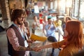 Young creative colleagues at office meeting shaking hands after receiving reward for a successful business year. Employees, office Royalty Free Stock Photo