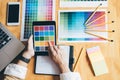 Young creative Graphic designer using graphics tablet to choosing Color swatch samples chart for selection coloring with work too Royalty Free Stock Photo