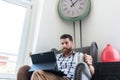 Young creative man working on a tablet connected to internet in co-working space