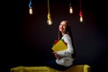 Young creative student with colorful lamps and books Royalty Free Stock Photo