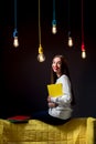 Young creative student with colorful lamps and books Royalty Free Stock Photo