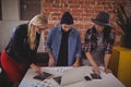 Young creative team using digital tablets while standing at coffee shop Royalty Free Stock Photo