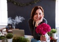 Young creative woman in a flower shop. A startup of florist business. Royalty Free Stock Photo