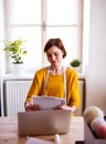 Young creative woman with laptop in a studio. A startup of tailoring business. Royalty Free Stock Photo