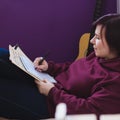 Woman sitting on a chair and compose a new song Royalty Free Stock Photo