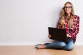 Young creative woman sitting in the floor with laptop./ Casual b