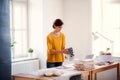 Young creative woman in a studio, startup of small tailoring business. Royalty Free Stock Photo