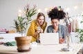 Young creative women with laptop in studio, startup business. Royalty Free Stock Photo