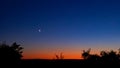 Young crescent moon on a clear sky at the end of the day in the summer Royalty Free Stock Photo