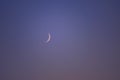 Young crescent moon on a clear sky at the end of the day in the summer Royalty Free Stock Photo