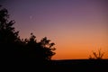 Young crescent moon on a clear sky at the end of the day in the summer Royalty Free Stock Photo