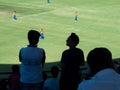 Young cricket fans, watching match in stadium.