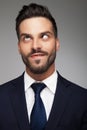 Young cross eyed businessman biting his lip and looks up Royalty Free Stock Photo