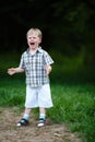 Young crying boy in summer park Royalty Free Stock Photo