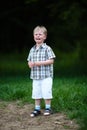 Young crying boy in summer park Royalty Free Stock Photo