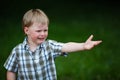 Young crying boy in summer park Royalty Free Stock Photo