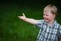 Young crying boy in summer park Royalty Free Stock Photo