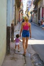 young Cuban mother going for a walk with her girl toddler in Havana
