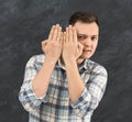 Young curious man peeking through palms Royalty Free Stock Photo