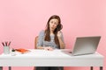 Young Curious woman scrutinizing looking through magnifying glass on pc laptop while sit work on project at office Royalty Free Stock Photo