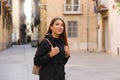 Young curious woman travelling and visiting Europe in winter time. Backpacker girl walking in Valencia admiring spanish Royalty Free Stock Photo