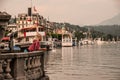 A young curly blonde woman gets some rest on the embankment in center of Lucerne, Switzerland.