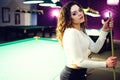 Young curly girl posed near billiard table Royalty Free Stock Photo