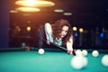 Young curly girl posed near billiard table Royalty Free Stock Photo