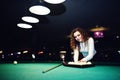 Young curly girl posed near billiard table Royalty Free Stock Photo