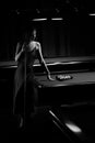 Young curly girl posed near billiard table. Sexy model at red dress. Royalty Free Stock Photo