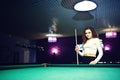 Young curly girl posed near billiard table Royalty Free Stock Photo