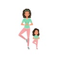 Young curly-haired mother with daughter doing yoga exercise. Motherhood concept. Healthy lifestyle. Girl and mom in